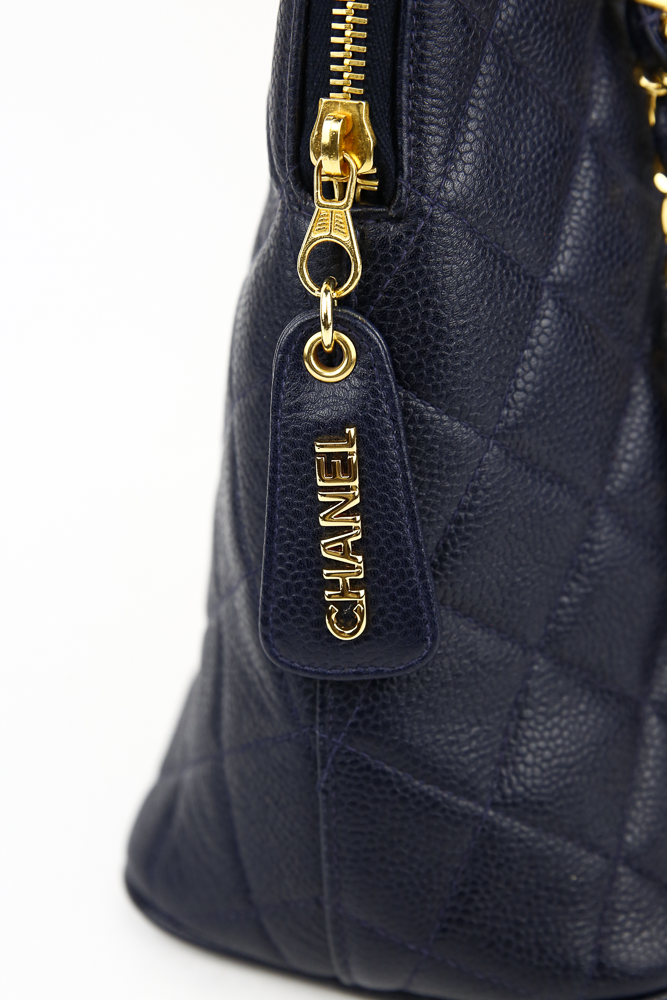 zipper pull view of Chanel Vintage Navy Caviar Quilted Dome Handbag