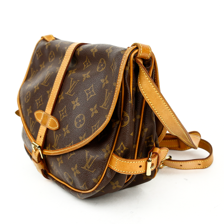 side view of Louis Vuitton Monogram Coated Canvas Saumur 25 Satchel