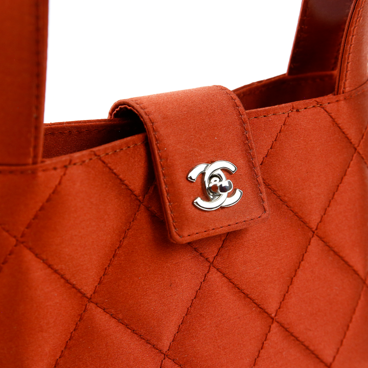 turnlock view of Chanel Burnt Orange Quilted Satin Mini Handle Bag