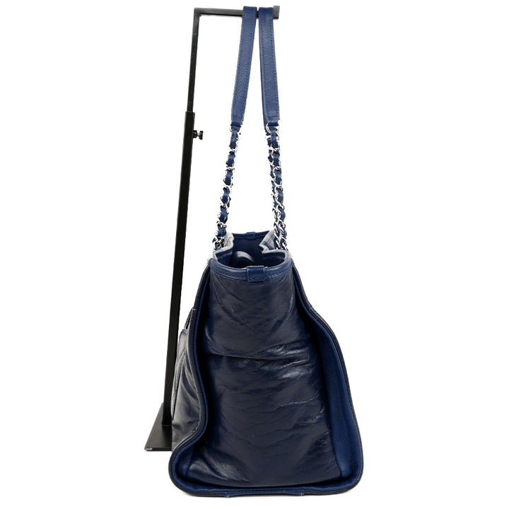 side view of Chanel Navy Glazed Calfskin Deauville Tote