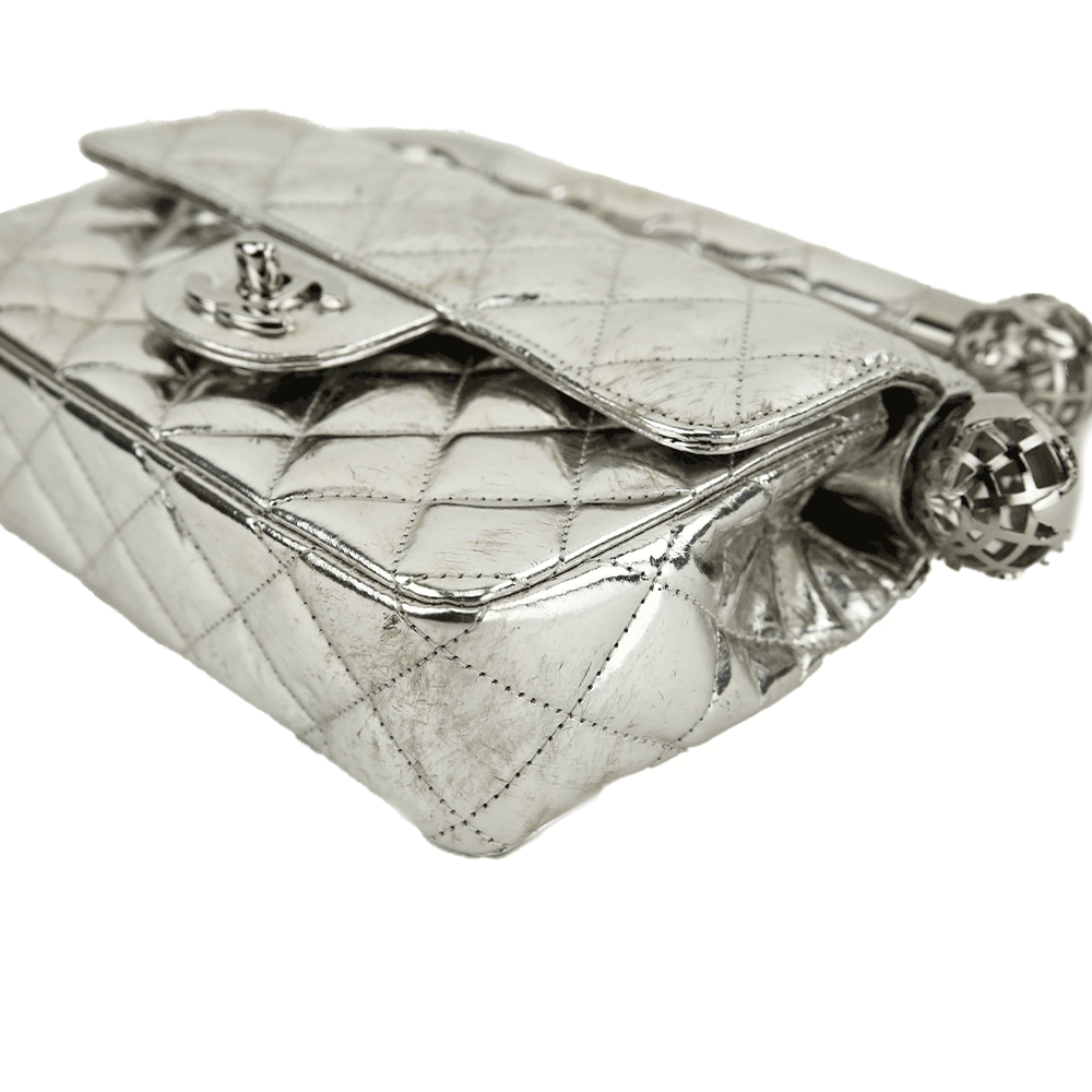 Corner view of Chanel Around The World Silver Quilted Clutch