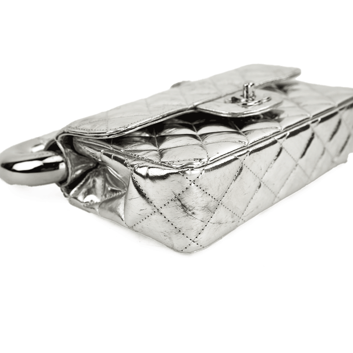 Corner view of Chanel Around The World Silver Quilted Clutch