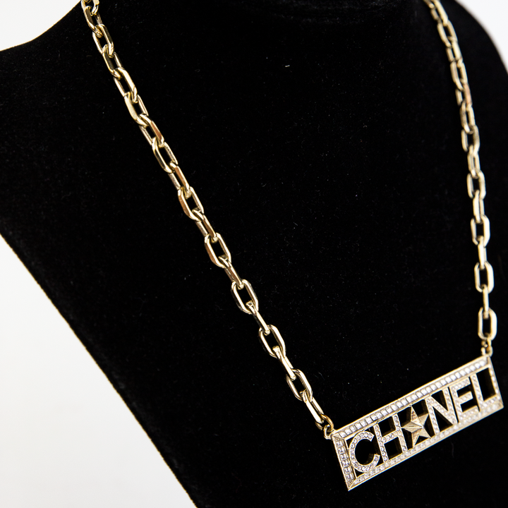Side view of Chanel Gold & Crystal Nameplate Necklace