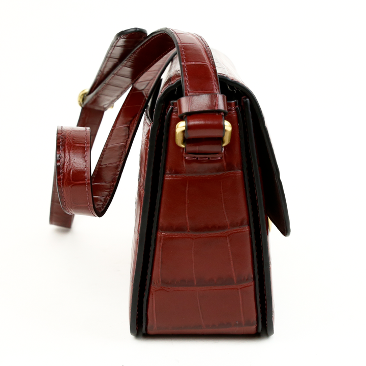 side view of Coach Studio Wine Croc Embossed Leather Satchel